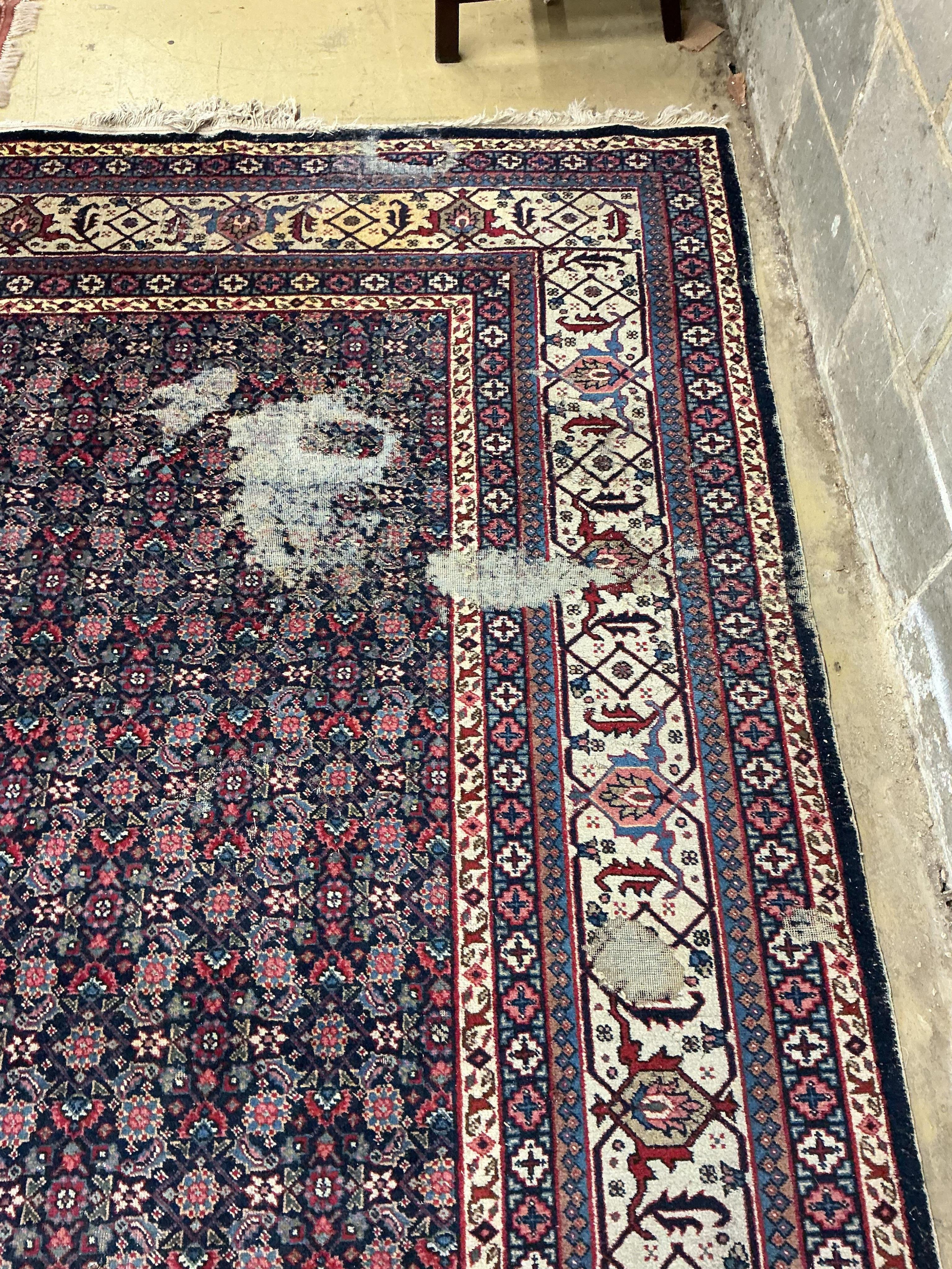 An early 20th century Tabriz blue ground floral carpet, moth damage, 440 x 340cm
